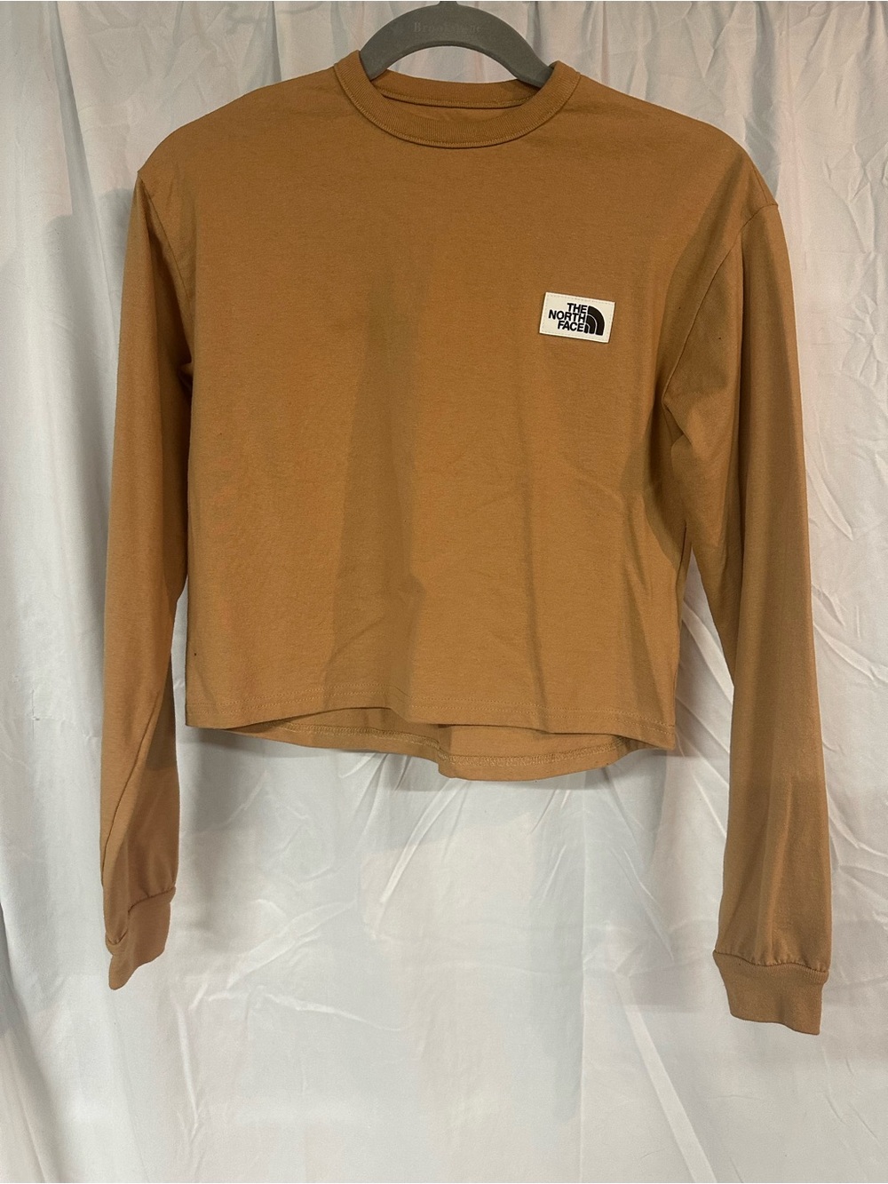 The North Face Women’s Long Sleeve Crop Tee in Mustard Yellow